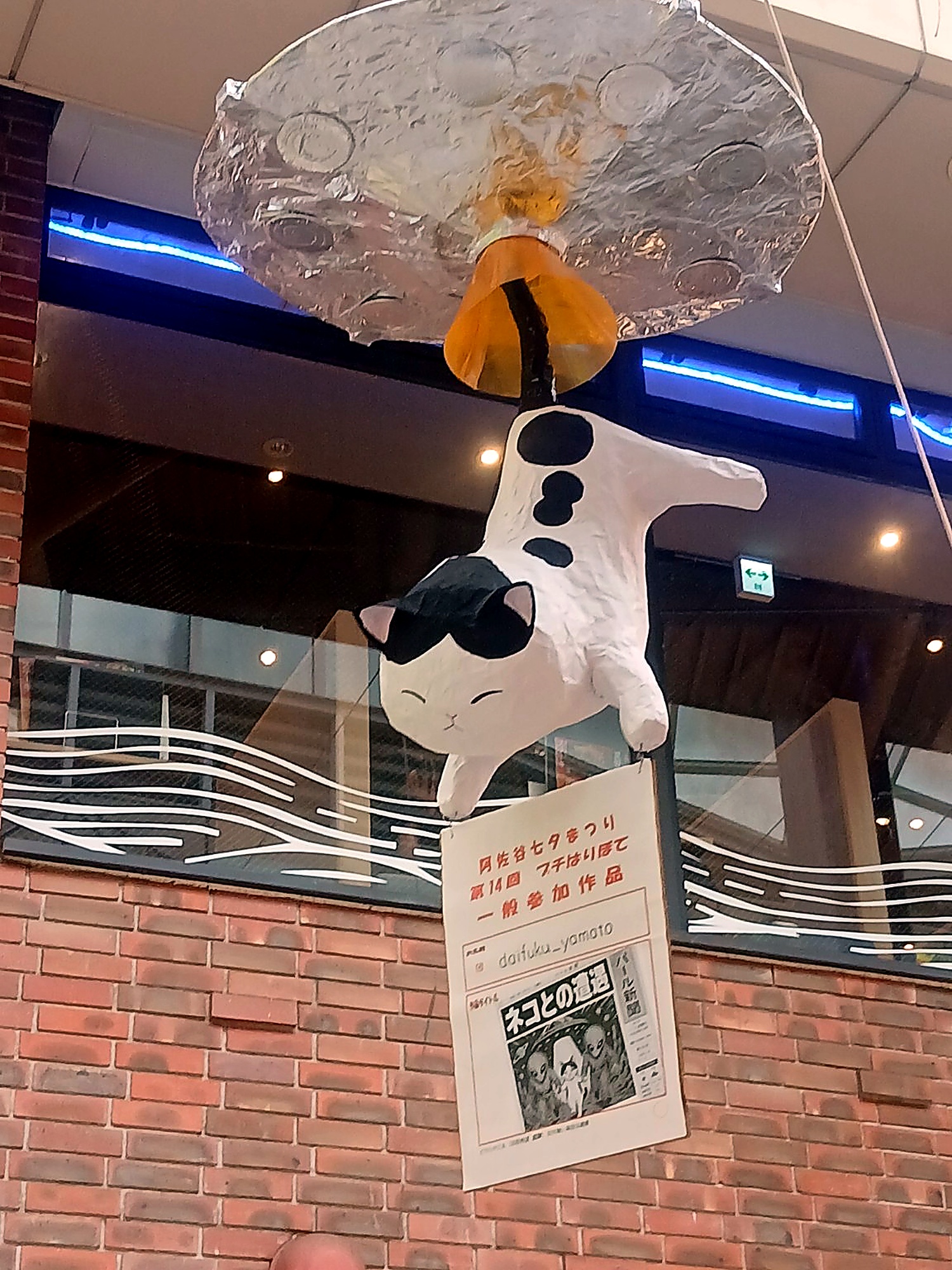 Black-and-white cat decoration hanging in the street