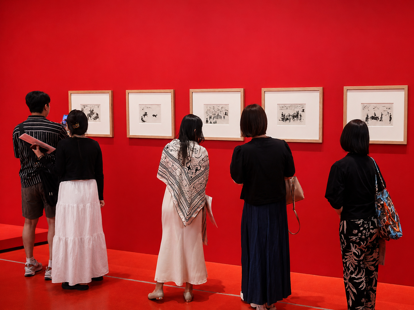 Visitors look at a group of Picasso's bullfighting works