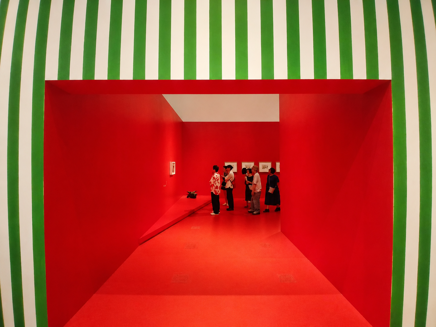 Red exhibition corridor presenting works by Picasso